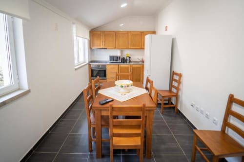 Dining area and kitchen with appliances | Welcome to Casa Rural "A Escola" – Your Tranquil Retreat in Pampilhosa da Serra