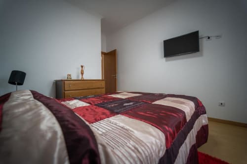 Comfortable bedroom with television and drawers | Welcome to Casa Rural "A Escola" – Your Tranquil Retreat in Pampilhosa da Serra