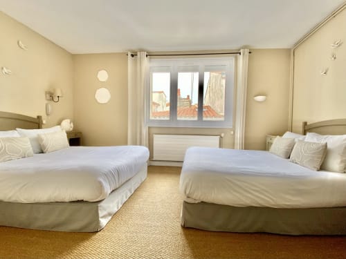 Bright twin bedroom with two double beds at Hôtel Maison Richet in Les Sables-d'Olonne, France