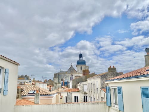Historic church with blue dome overlooking Les Sables-d'Olonne rooftops near Hôtel Maison Richet