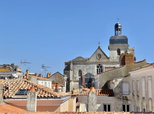 Church with dome and cross overlooking rooftops in Les Sables-d'Olonne, near Hôtel Maison Richet