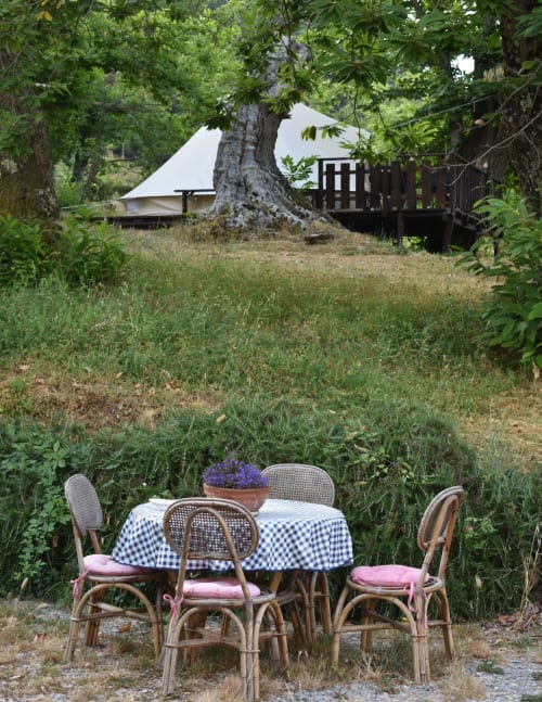 Tavolino immerso nel verde vicino ad una tenda glamping nella maremma toscana