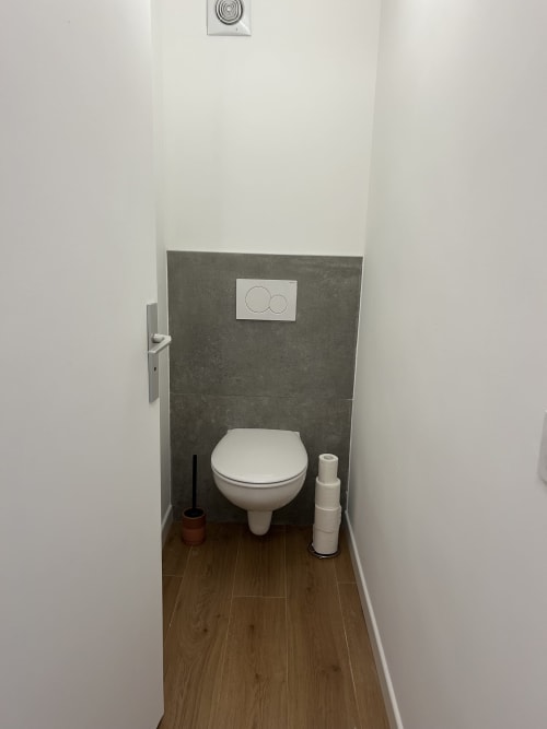 Salle de bain moderne de l'hôtel Mazet Cavalaire à Cavalaire-sur-Mer avec carrelage gris et parquet