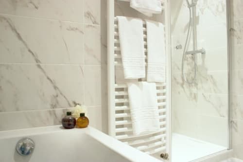 Towels and bath tub with shower room | Discover Sophistication in the Junior Suite Grand Cru