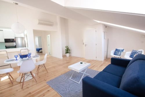 Living area with dining table, kitchen, and bedroom view | Experience Comfort and Style at Loving Chiado 1 in Lisbon