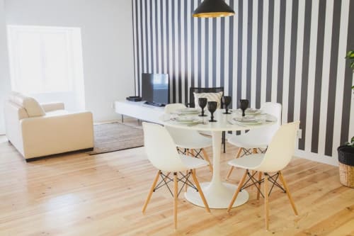 Living area and dining table with utensils | Relax and Unwind at Loving Chiado 2 – Your Perfect Lisbon Stay