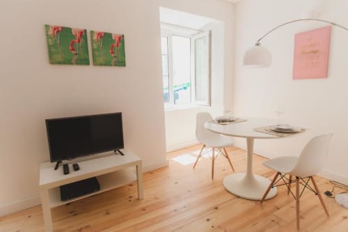 Dining area with television and big lamp | Loving Chiado 5 – Your Cozy Escape in the Heart of Lisbon
