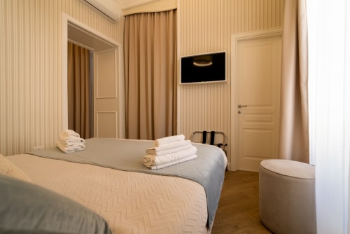 Camera da letto tripla moderna presso Le Boutique del Centro, Napoli con due letti, TV a schermo piatto e arredamento contemporaneo