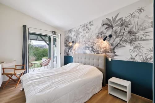Modern bedroom at Villa Ongizatea cottage in Urrugne with mountain view, balcony, and botanical mural