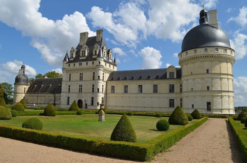 Château de Valençay in Luçay-le-Mâle, France with formal gardens and manicured hedges under blue sky