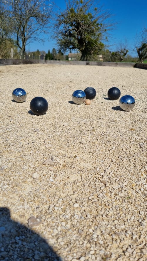 Boules game setup on sandy court at Ilot Cosy and Spa, Luçay-le-Mâle with metal balls and jack