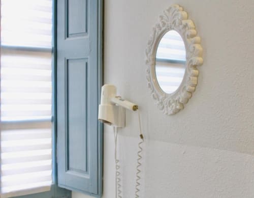 Mirror and hair blower | Spacious Quadruple Rooms – Perfect for Families and Friends