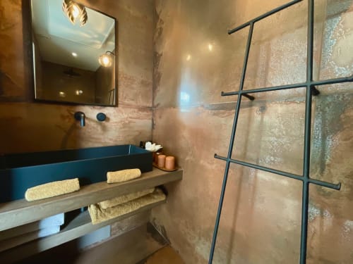 Modern bathroom at Provence Km28 in Gordes with blue sink, rainfall shower, heated towel rack, and ambient lighting