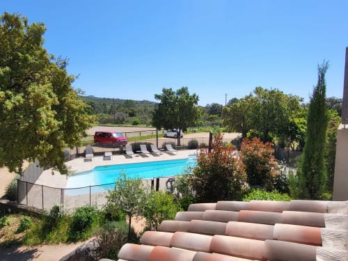 Villas Lantana pool and grounds in Lecci with loungers, trees, and hillside views