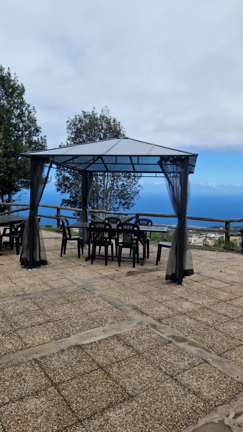 Covered pergola with dining area overlooking Icod de los Vinos and sea views at Casonas de marengo