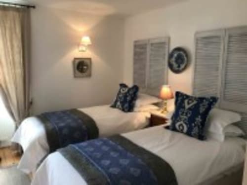 Twin beds in Ciboulette room at Manoir De Rieuzal B&B, Loubressac, with mountain views and blue decor accents