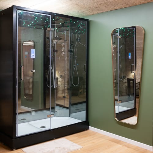Luxury steam shower cabin at Pavillon Des Millesimes SPA with green walls and smart controls in Lussac