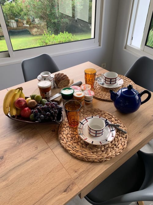 Breakfast setup at Villa Ongizatea with fresh fruit, teapot, pastries, and tea service overlooking garden views.