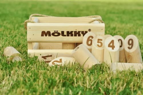 Mölkky wooden game set with numbered pins on grass at Ilot Cosy and Spa