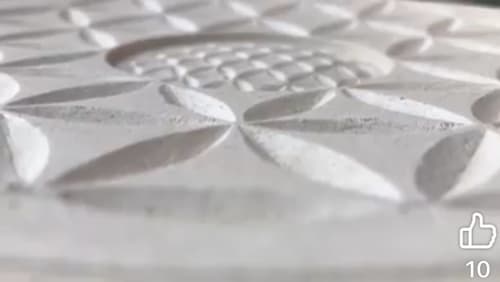Close-up of textured white bedding with geometric quilted pattern at La Cachette d'Oona B&B, Saint-Jean-de-Monts