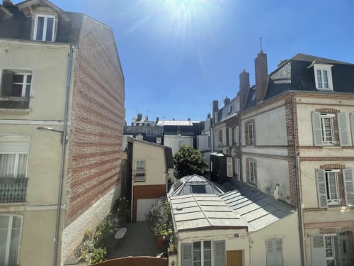 Hotel Le Trouville city view overlooking Trouville-sur-Mer rooftops and mansard-roofed buildings