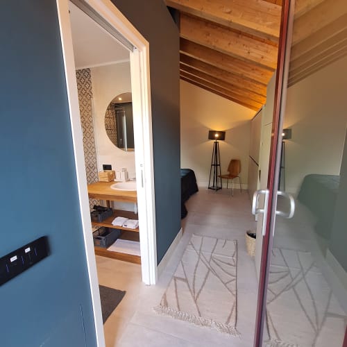Modern guest room entry at Locanda del Sasso, Crodo with ensuite bathroom and mountain lodge ambiance