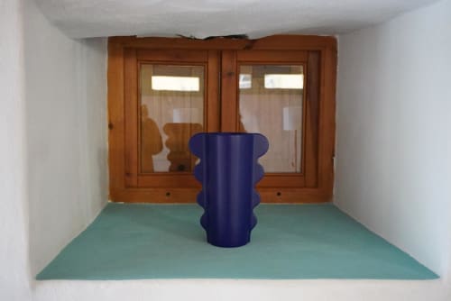 Modern blue sculptural column in mint-green floored cottage entryway with wooden double doors at Casonas de Marengo, Icod de