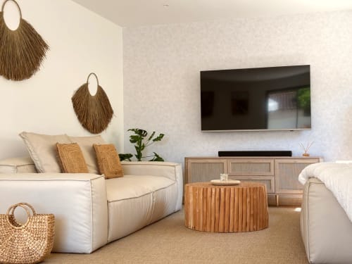 Suite elegante presso La Maison D'ambrine con sedute rivestite in crema, accenti tessuti naturali e TV a schermo piatto moderno