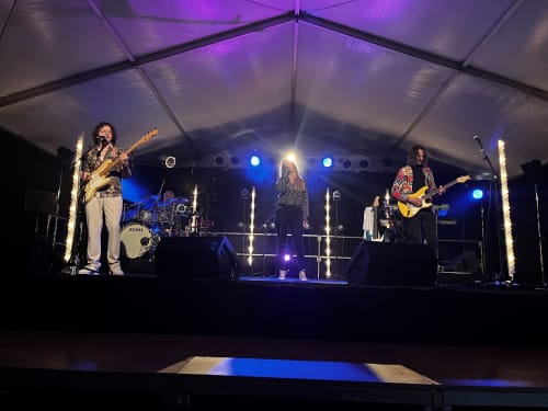 Live band performing under purple tent at Domaine de l'Ocrerie, Pourrain France