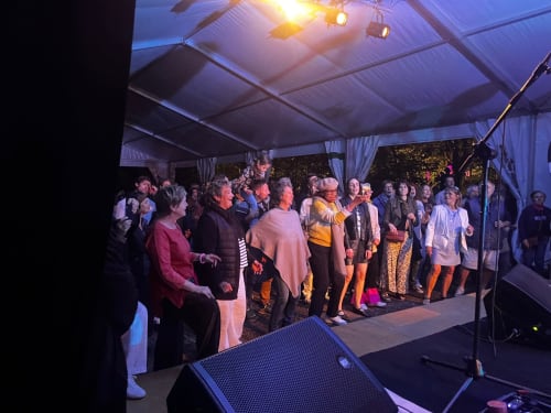 Evening event at Domaine de l'Ocrerie tent venue in Pourrain with guests gathered under warm lighting
