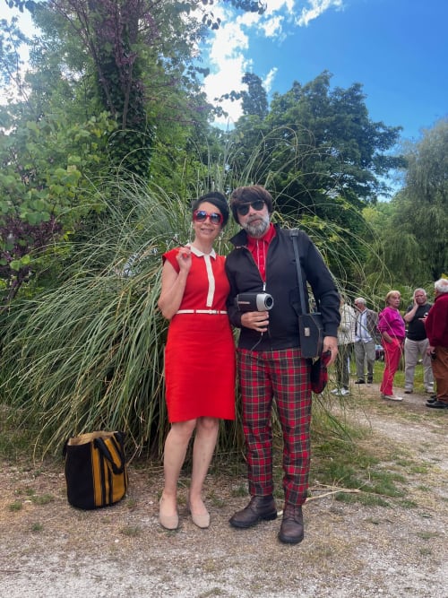 Couple posing at Domaine de l'Ocrerie B&B in Pourrain, France with ornamental grasses and gardens