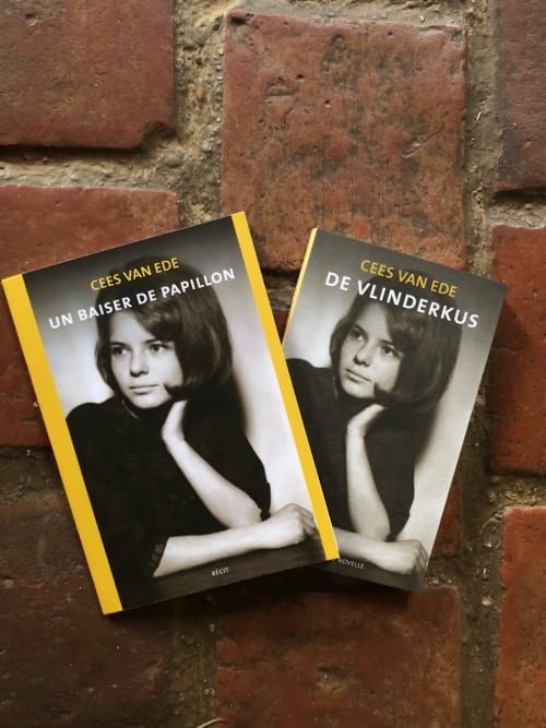 Two French books by Cees van Ede displayed on brick wall at Domaine de l'Ocrerie in Pourrain