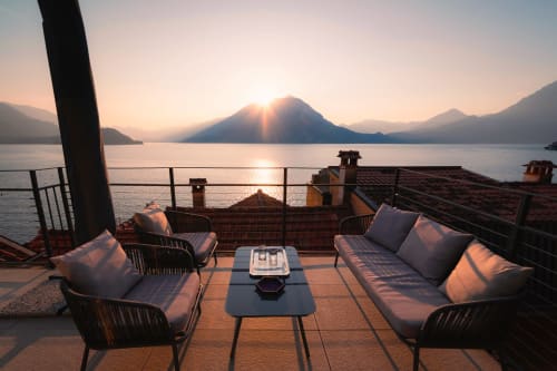 Sunset view from La Risorgente balcony in Varenna overlooking Lake Como with lounge seating