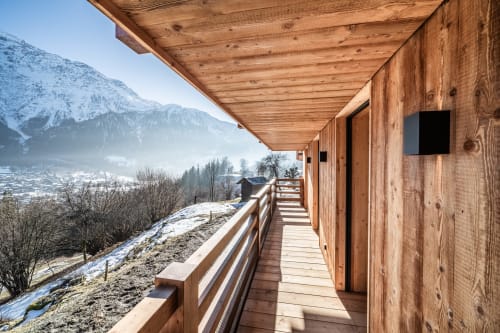 Wooden chalet deck overlooking snowy Mont-Blanc mountains at Le Chalet Mont-Blanc, Les Houches Chamonix