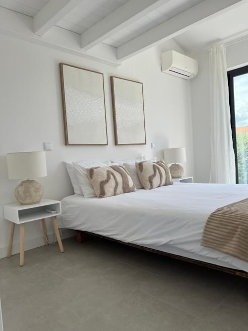 Modern bedroom at Casa Beliche villa in Bordeira with sea view, white bedding, neutral décor, and minimalist furnishings