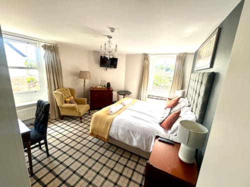 John Martin Superior King Room at The Railway Hotel Haydon Bridge with river view, king bed, seating area, and windows