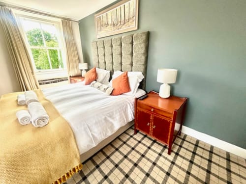 Superior King Room at The Railway Hotel Haydon Bridge with tufted headboard, river view window, and elegant decor
