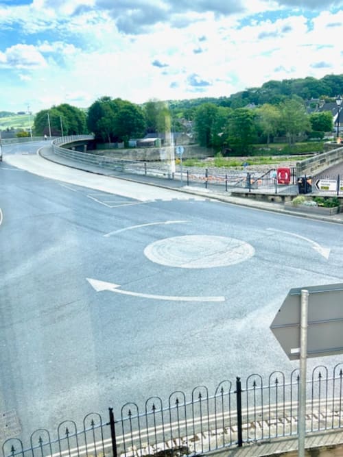 Curved bridge and river view at The Railway Hotel Haydon Bridge, with green hills and countryside landscape