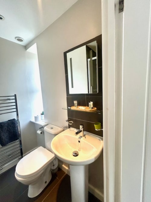 Modern bathroom in John Martin Superior King Room at The Railway Hotel, Haydon Bridge, featuring pedestal sink and heated