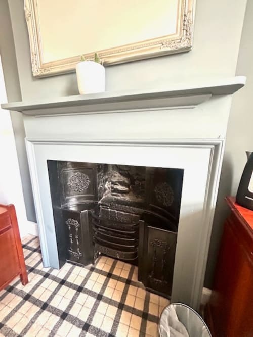 Fireplace in Cookson Deluxe Room at The Railway Hotel Haydon Bridge with decorative black insert and mantel shelf