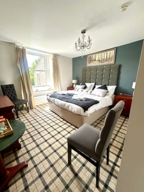 Ratcliffe Superior King Room at The Railway Hotel, Haydon Bridge with river view, tufted headboard, and elegant decor