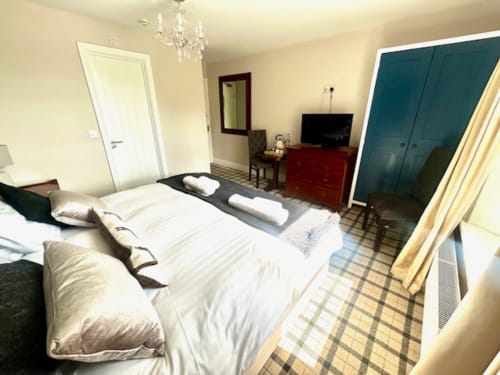 Ratcliffe Superior King Room at The Railway Hotel Haydon Bridge with river views, white bedding, and cream walls