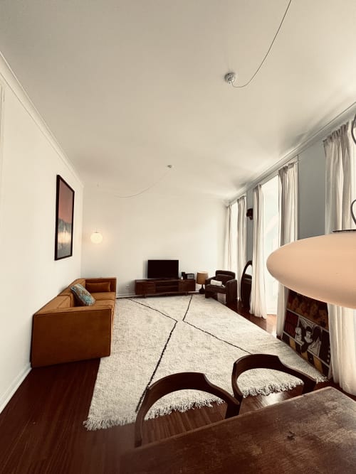 Spacious living room in luxury 3-bedroom apartment at Royal Prince Garden Apartments, Lisbon with leather sofa, dining table,