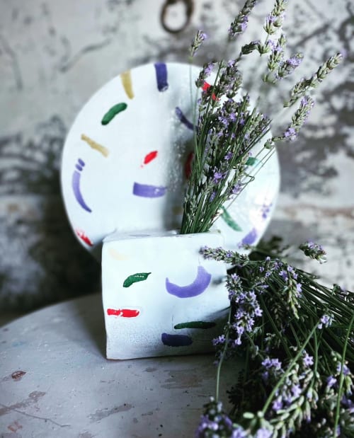 Decorative ceramic vases with abstract faces and lavender flowers at La Cascina di Bea B&B in Torre Boldone, Bergamo