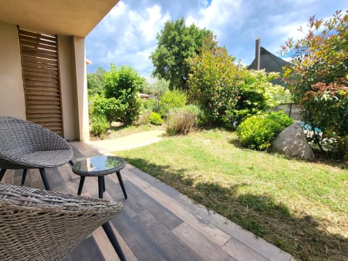 Studio terrace at Villas Lantana in Lecci with outdoor lounge, garden views, and Mediterranean landscape
