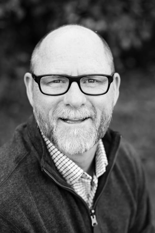 Smiling man with beard and glasses, property manager at Habitation I'SEO in Sainte-Anne, Guadeloupe