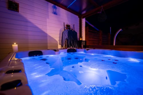 Baignoire illuminée à la Villa Eden Bleu à Biscarrosse avec éclairage bleu et jets bouillonnants au crépuscule