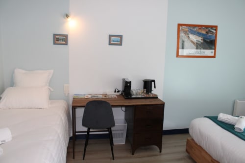 Comfortable quadruple bedroom at Domaine des Piérs, Grandcamp-Maisy with twin beds, work desk, and garden views