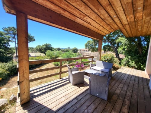 Wooden pergola terrace with lounge seating overlooking Lecci countryside at Villas Lantana