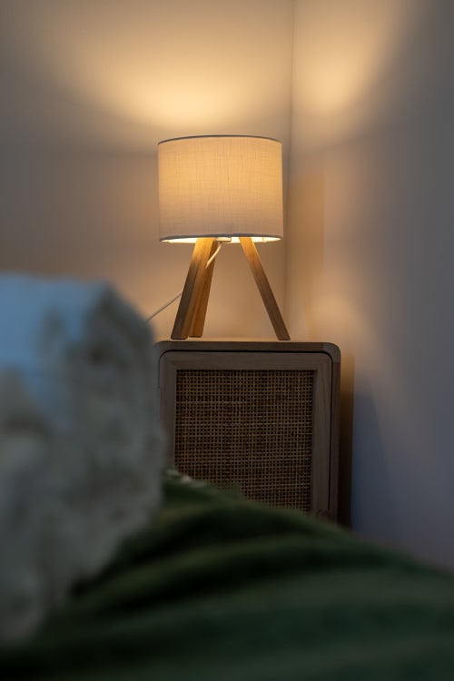 Modern tripod lamp with cream shade glowing warmly in Lake House villa at Corvatos Casas do Monte, Almodôvar